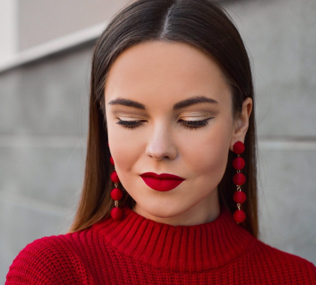 Woman wearing red lipstick and a red sweater