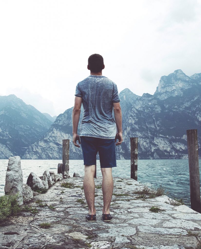 man looking out at mountains