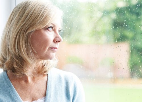 Older woman staring out the window
